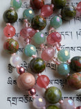 Dark green Unakite beads with pink tints. Dark pink Cherry Quartz. Light green Adventurine. Light brown Rosewood framed with copper Czech glass. The pale pink knots between the beads and bead units protect and showcase the beads.