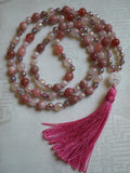 Hand-knotted mala with 8mm Pink Tourmaline, faceted White Agate, and faceted Gray Agate beads with globe-shaped matte Quartz guru and salmon pink tassel.