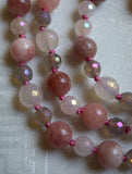 Close up view of 8mm Pink Tourmaline, 8mm faceted White Agate, 6mm faceted White and Gray Agate beads. Salmon pink knots between beads protect and showcase the beads of this one-of-a-kind design beautifully.