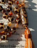 Close up view of 10x30mm barrel-shaped Six-eye "Dzi " Agate guru.