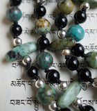 Light green with brown and black  African Turquoise (8mm rounds and 5x15mm flat chip beads) blend nicely with the bright turquoise Cuprite beads and 6mm Black Onyx. Black knots between the beads and bead units protect and showcase the beads.