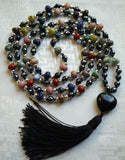 Full view of mala with colorful rondelle-shaped gemstone beads framed with faceted Hematite, 6mm faceted Black Agate, and a heart-shaped Obsidian guru with black sutra/tassel.