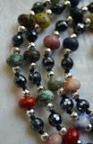 A beautiful blend of faceted Black Agate beads with rondelle-shaped multicolored gemstones framed with faceted Hematite beads. The knots between the beads and bead units showcase and protect the beads of this design.