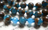 close up view of Blue Mosaic Quartz beads framed with 6mm faceted Blue Agate. The marine blue knots between the beads protects and showcases the beads of this design.