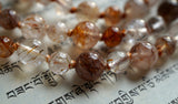 Close up view of 8mm and 6mm Brown Rutilated Quartz beads with variegated cinnamon brown knots between to protect and showcase the beads beautifully.