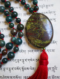 This  20x30mm oval Dragon Blood Jasper guru with a deep red tassel spilling from the base of the bead brings this powerful design full circle.