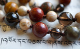 Close up view of Red Creek Jasper, Smoky Quartz, and White African Opal beads. The chocolate brown knots between beads protect and showcase the beads of this one-of-a-kind design.