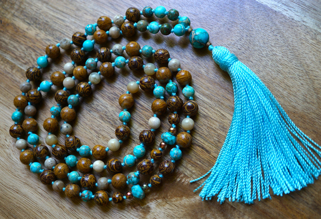 Full view of mala with brown Elephant Jasper, light blue Aqua Impression Jasper, creamy White African Opal beads and sky blue tassel.
