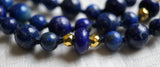 A rondelle-shaped Lapis bead framed with 4mm faceted gold metal beads marks the quarter and three-quarter mark of this design. These beads add visual interest to the mala and act as lovely accents to the guru.
