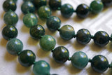 Close up view of 8mm Moss Agate beads. The forest green knots between beads showcase and protect the beads of this design.