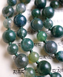 Close up view of dark green Moss Agate beads with forest green knots between to protect and showcase the beads of this design.