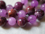 Close up view of 8mm Crazy Lace Agate and 6mm Purple Jade beads. Bright purple knots between the beads protect and showcase the beads of this design beautifully.