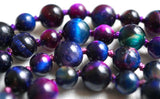 Rainbow Tiger Eye beads are bold blue, pink, purple, and green in color. Their shimmering, chatoyant waves of  iridescent color are characteristic of Tiger Eye beads.  