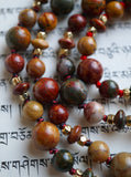 Red Creek Jasper includes warm, earthy hues of red, gold, gray, rust, cream and brown. The variegated knots between the beads and bead units protect and showcase the beads beautifully.