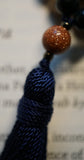 8mm Goldstone bead and navy blue tassel.